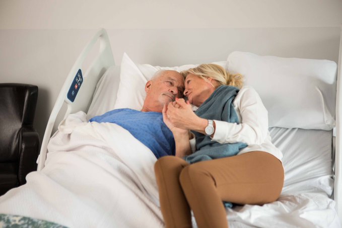 A couple sharing a Cuddle Bed widened to a double, the Ook Snow ALL by Umano Medical